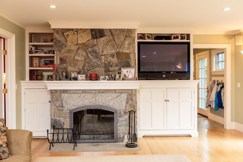 18 Thomas Road Wellesley, MA 02482 - Photo 13 of 24 a living room with a flat screen tv and a fireplace