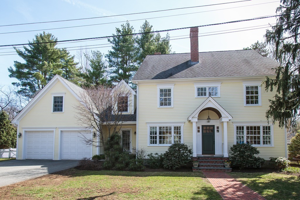 18 Thomas Road Wellesley, MA 02482 - Photo 2 of 24 a front view of a house with a yard and garage