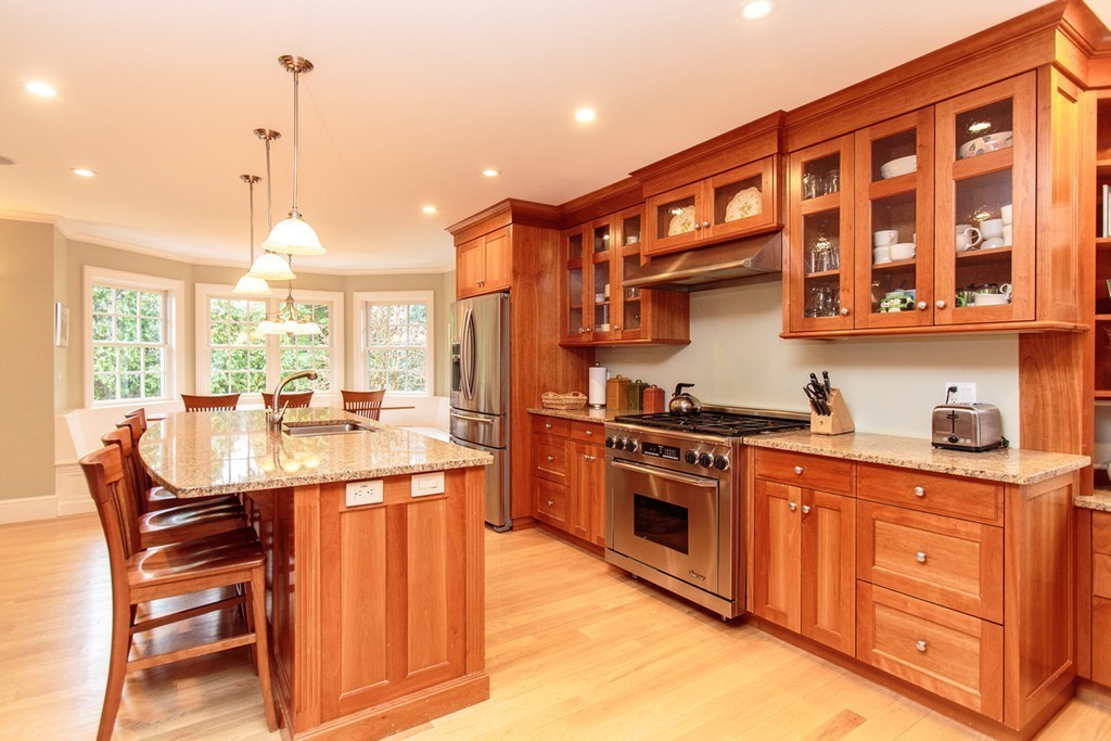 18 Thomas Road Wellesley, MA 02482 - Photo 7 of 24 a kitchen with stainless steel appliances granite countertop a stove a sink dishwasher and a refrigerator with wooden floor