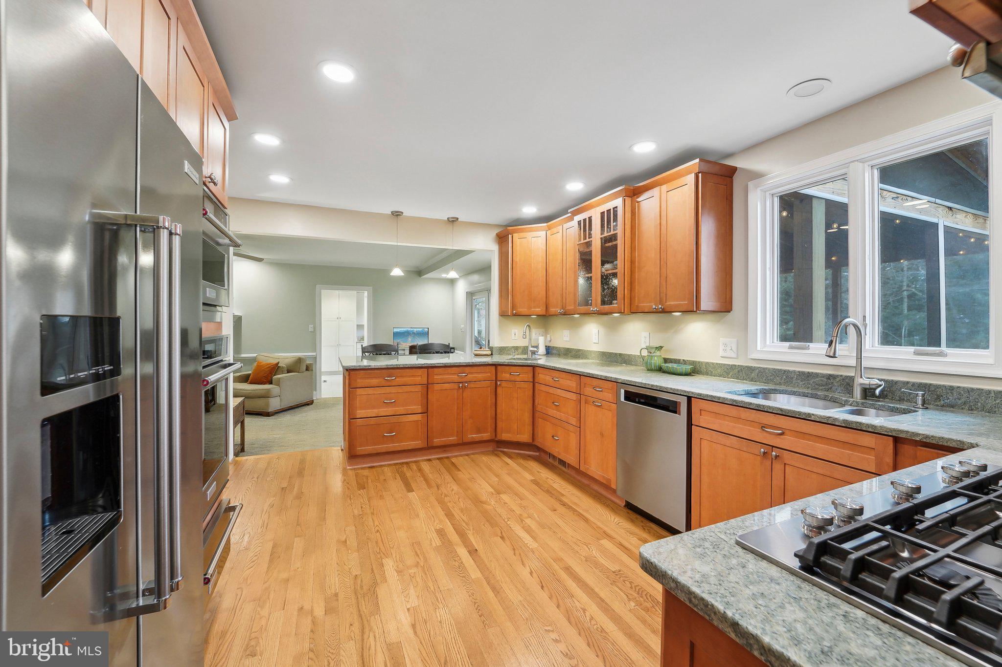 3 Emerson Road Severna Park, MD 21146 - Photo 11 of 65 a large kitchen with stainless steel appliances granite countertop a lot of counter space and wooden floor
