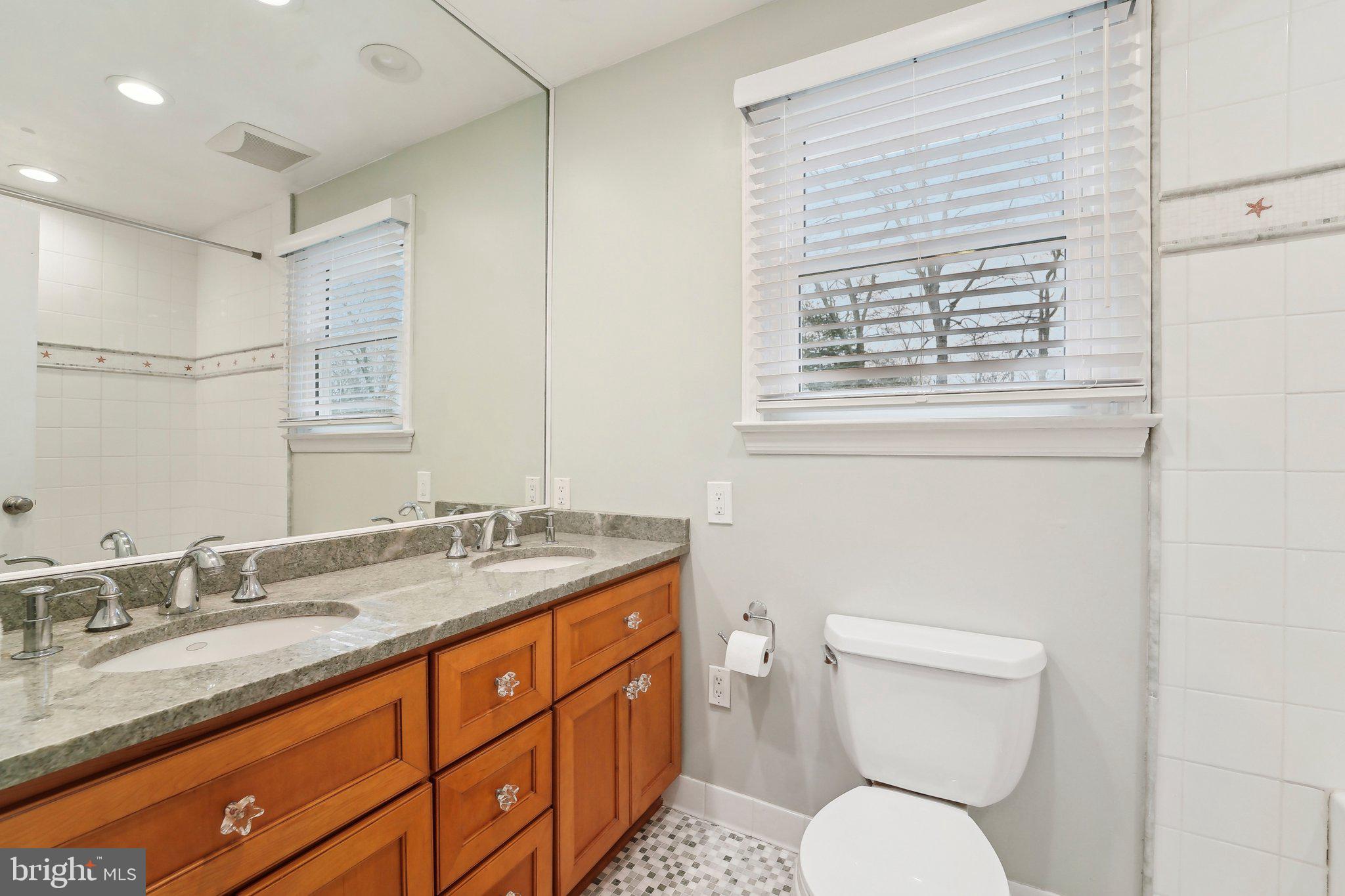 3 Emerson Road Severna Park, MD 21146 - Photo 32 of 65 a bathroom with a granite countertop toilet sink and mirror