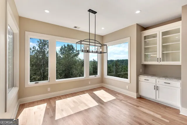 a view of a kitchen with a sink and wooden floor