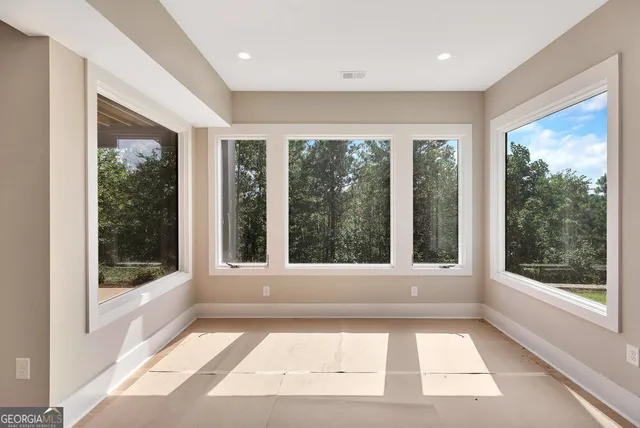 a view of a bathtub in a room with a large window