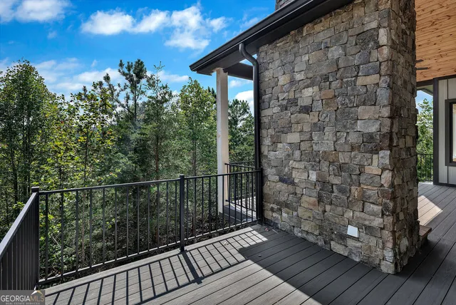 a view of balcony with wooden floor and fence
