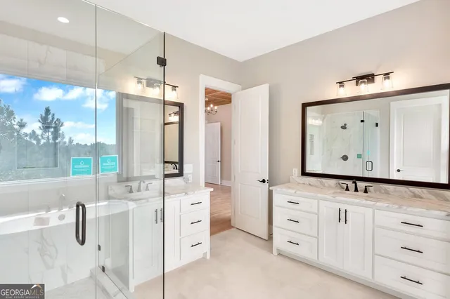 a bathroom with a double vanity sink mirror and bathtub