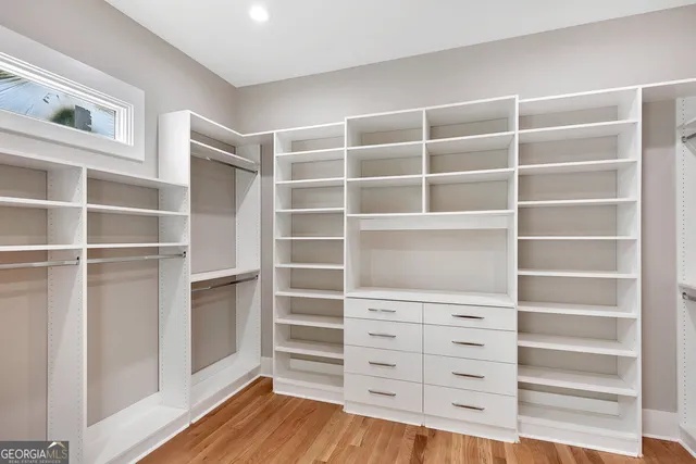 a view of walk in closet with empty racks