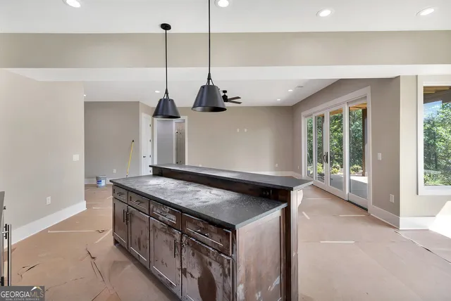 a kitchen with stainless steel appliances granite countertop a sink a stove and a wooden floor