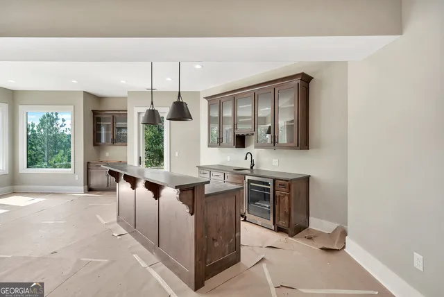 a spacious bathroom with a granite countertop sink and a mirror