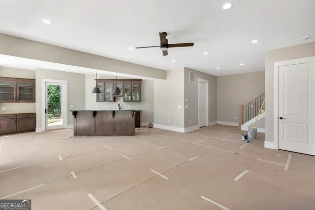 a big room with chandelier and windows
