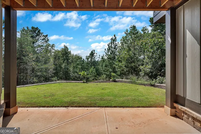 a view of a livingroom with a ceiling fan and window