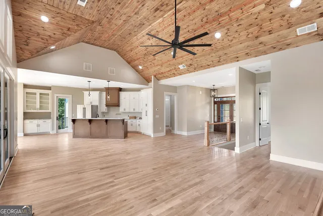 a big room with wooden floor and windows