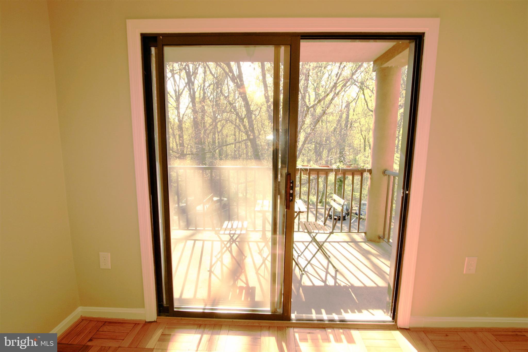4114 Davis Place Northwest, Unit 210 Washington, DC 20007 - Photo 8 of 19 a view of an empty room with wooden floor and a window