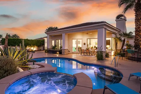 a view of a swimming pool with outdoor seating