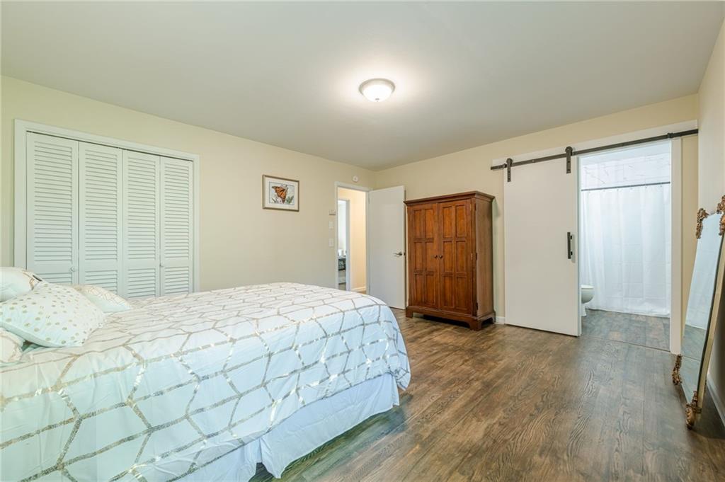 1874 Pinetree Trail Gainesville, GA 30501 - Photo 11 of 15 a bedroom with a bed and wooden floor