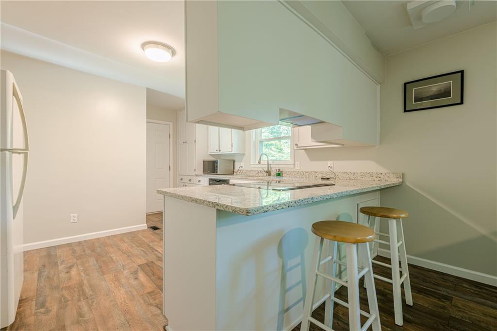 1874 Pinetree Trail Gainesville, GA 30501 - Photo 7 of 15 a kitchen with a sink cabinets and wooden floor
