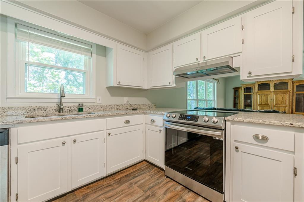 1874 Pinetree Trail Gainesville, GA 30501 - Photo 8 of 15 a kitchen with granite countertop cabinets stainless steel appliances and a sink