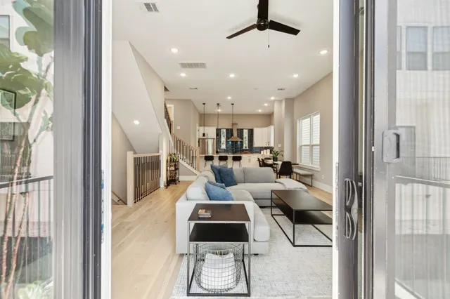 a living room with furniture and a chandelier