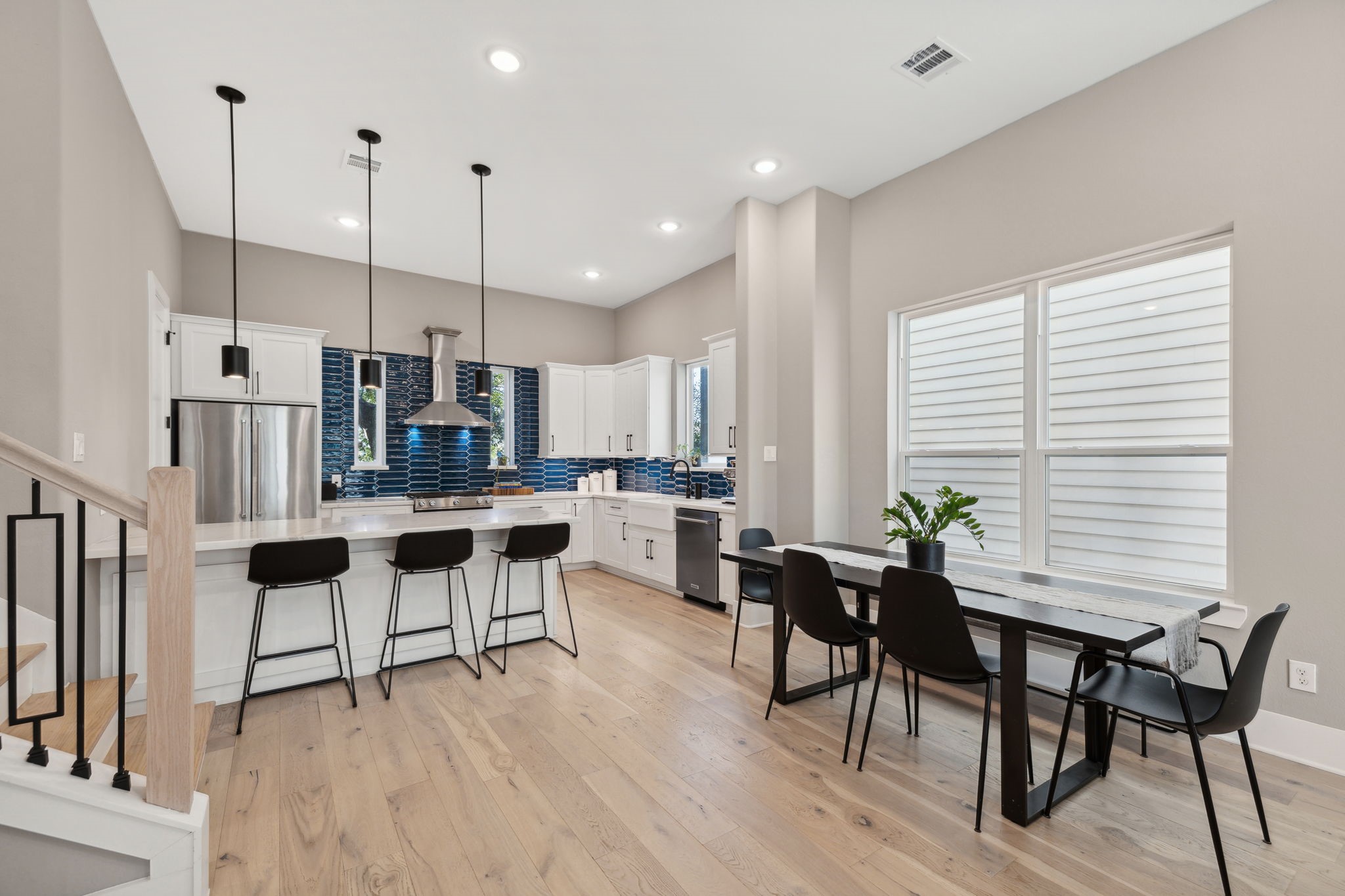 1413 West 23rd Street Houston, TX 77008 - Photo 15 of 39 a kitchen with stainless steel appliances kitchen island granite countertop a table chairs and a wooden cabinets