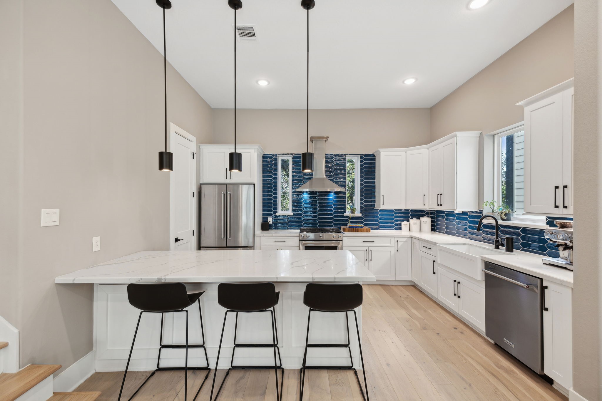 1413 West 23rd Street Houston, TX 77008 - Photo 16 of 39 a kitchen with stainless steel appliances kitchen island granite countertop a stove a sink and white cabinets with wooden floor