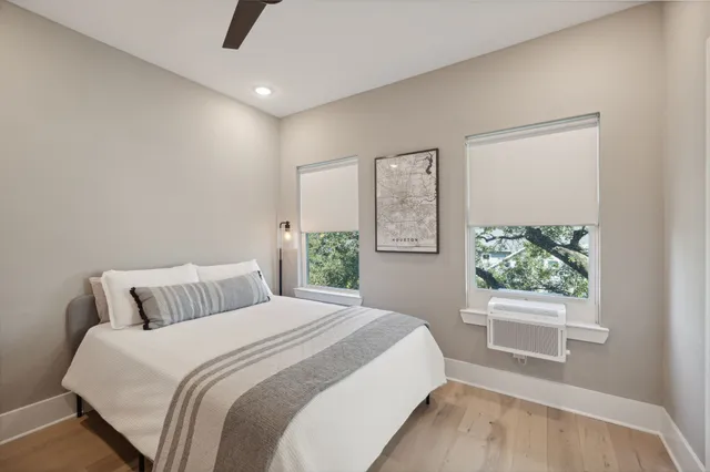 a bedroom with a large bed and a window