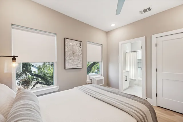 a bedroom with a large bed and wooden floor