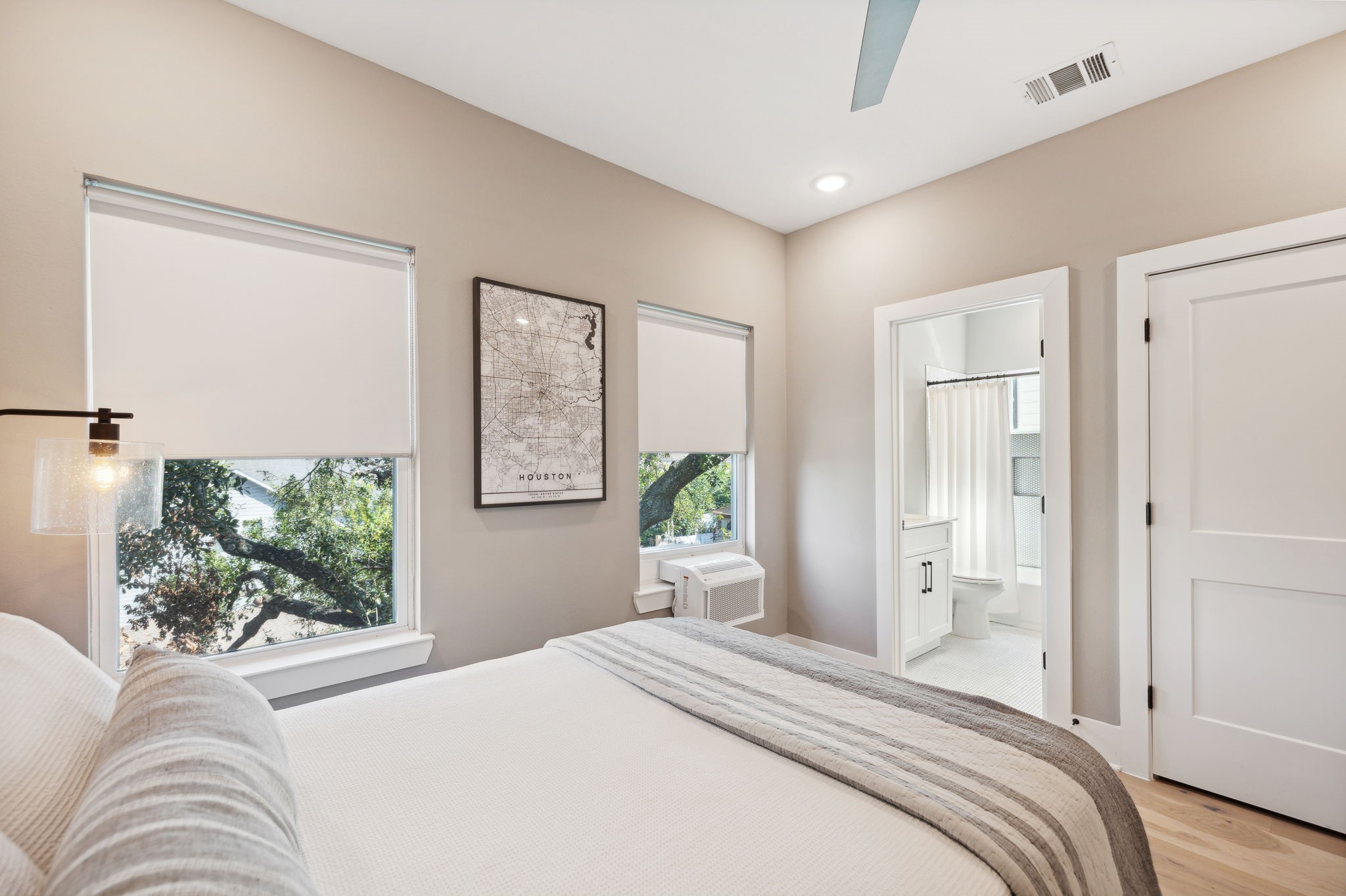 1413 West 23rd Street Houston, TX 77008 - Photo 31 of 39 a bedroom with a large bed and wooden floor