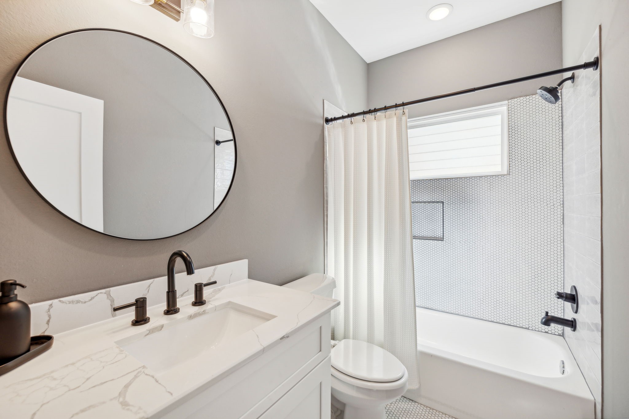 1413 West 23rd Street Houston, TX 77008 - Photo 32 of 39 a bathroom with a sink a toilet and a mirror