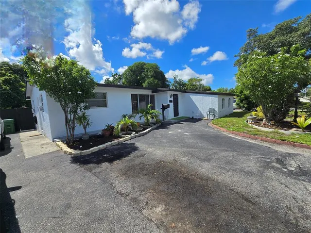 a view of backyard with deck and garden