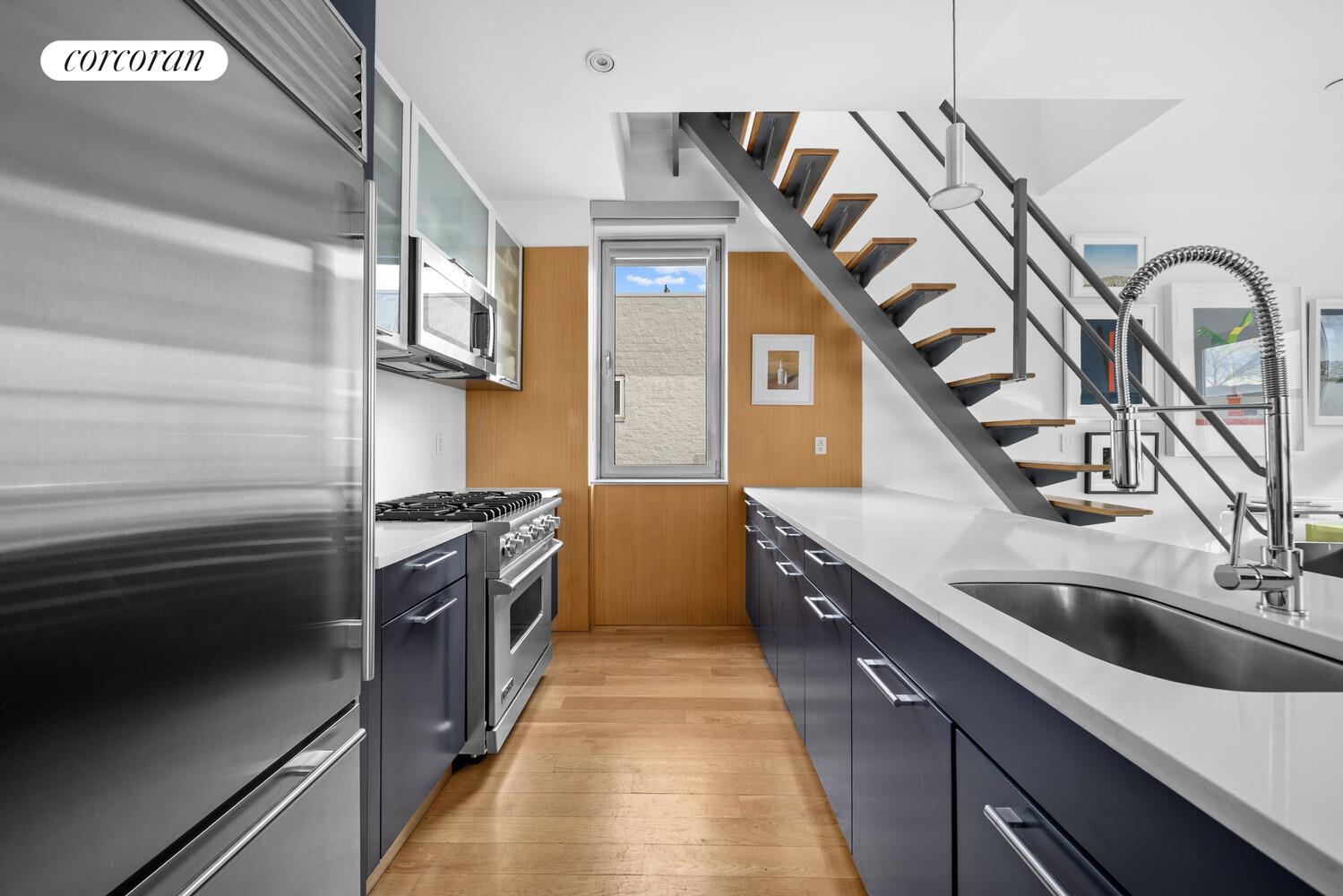 117 South 3rd Street, Unit 5A Brooklyn, NY 11249 - Photo 5 of 10 a kitchen with stainless steel appliances granite countertop a sink and stove
