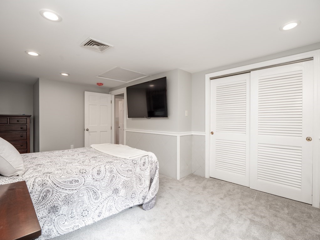 82 Rangeway Road Billerica, MA 01862 - Photo 12 of 40 a bedroom with a bed and a flat screen tv