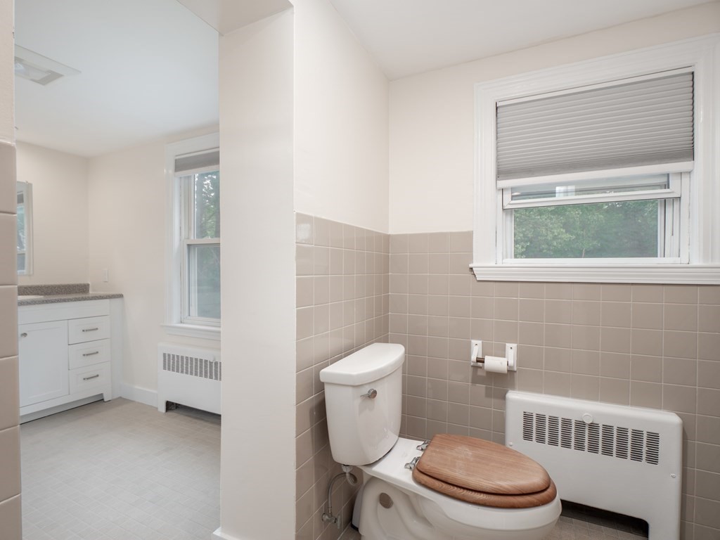 82 Rangeway Road Billerica, MA 01862 - Photo 13 of 40 a white toilet sitting next to a bathroom sink