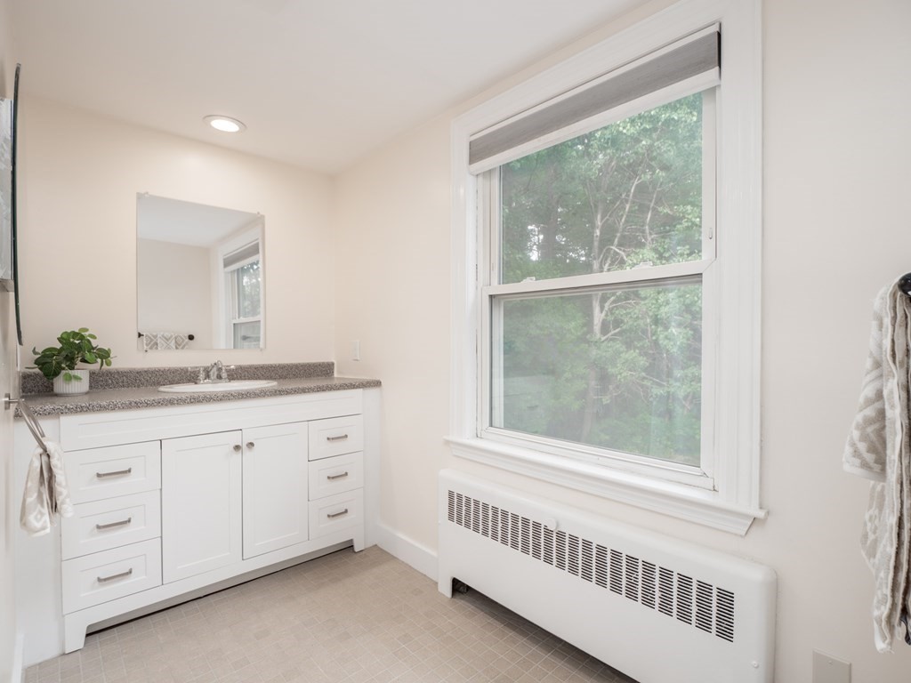 82 Rangeway Road Billerica, MA 01862 - Photo 14 of 40 a bathroom with a granite countertop sink and a window