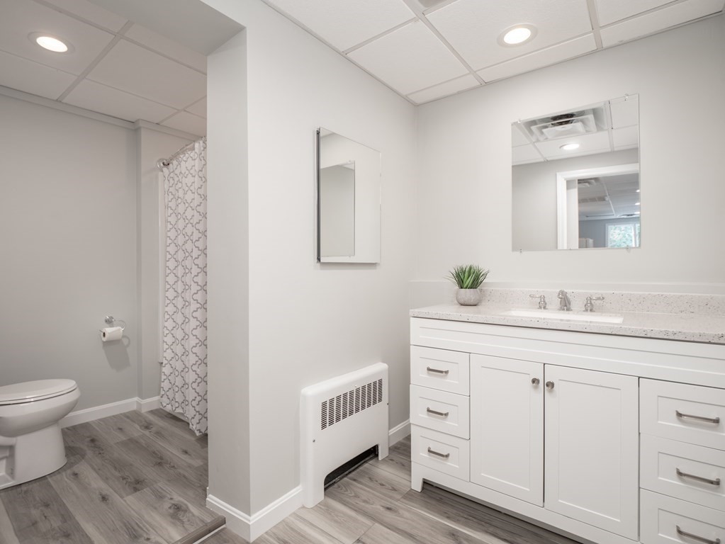 82 Rangeway Road Billerica, MA 01862 - Photo 16 of 40 a spacious bathroom with a double vanity sink a toilet and a mirror