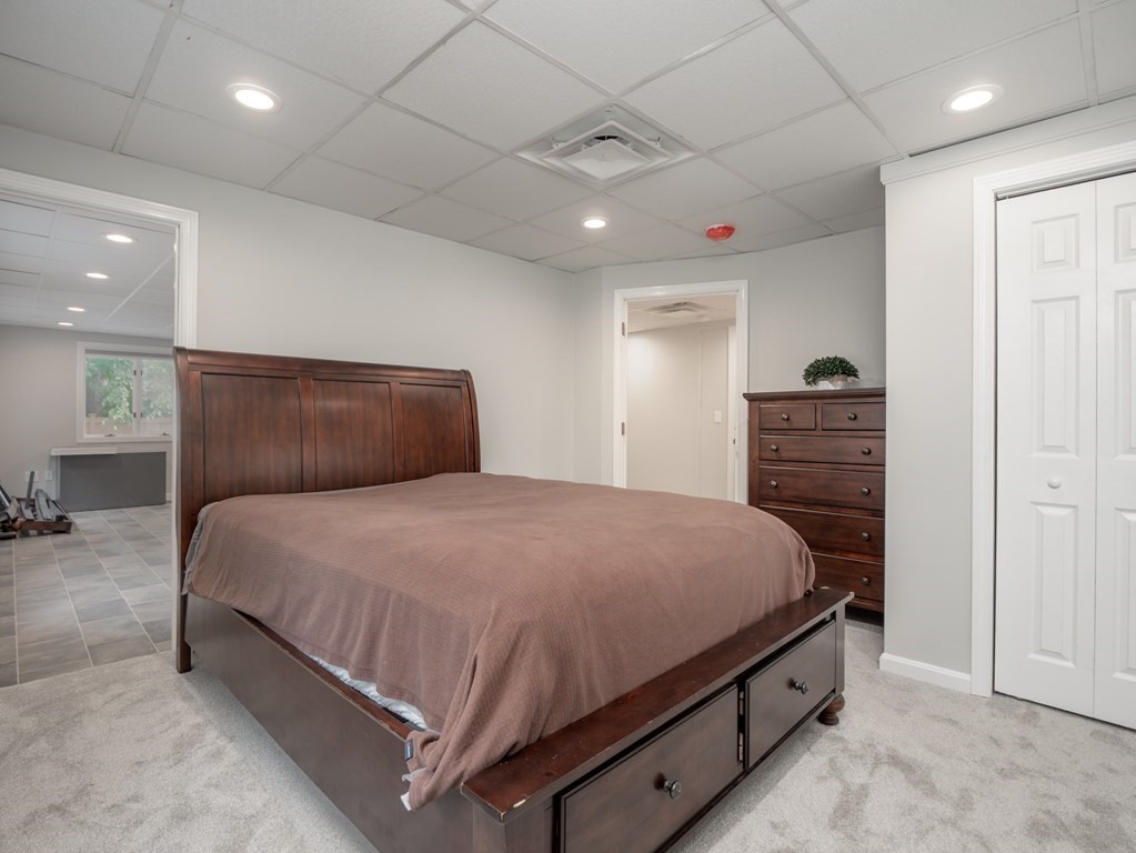 82 Rangeway Road Billerica, MA 01862 - Photo 17 of 40 a bedroom with a bed and a walk in closet