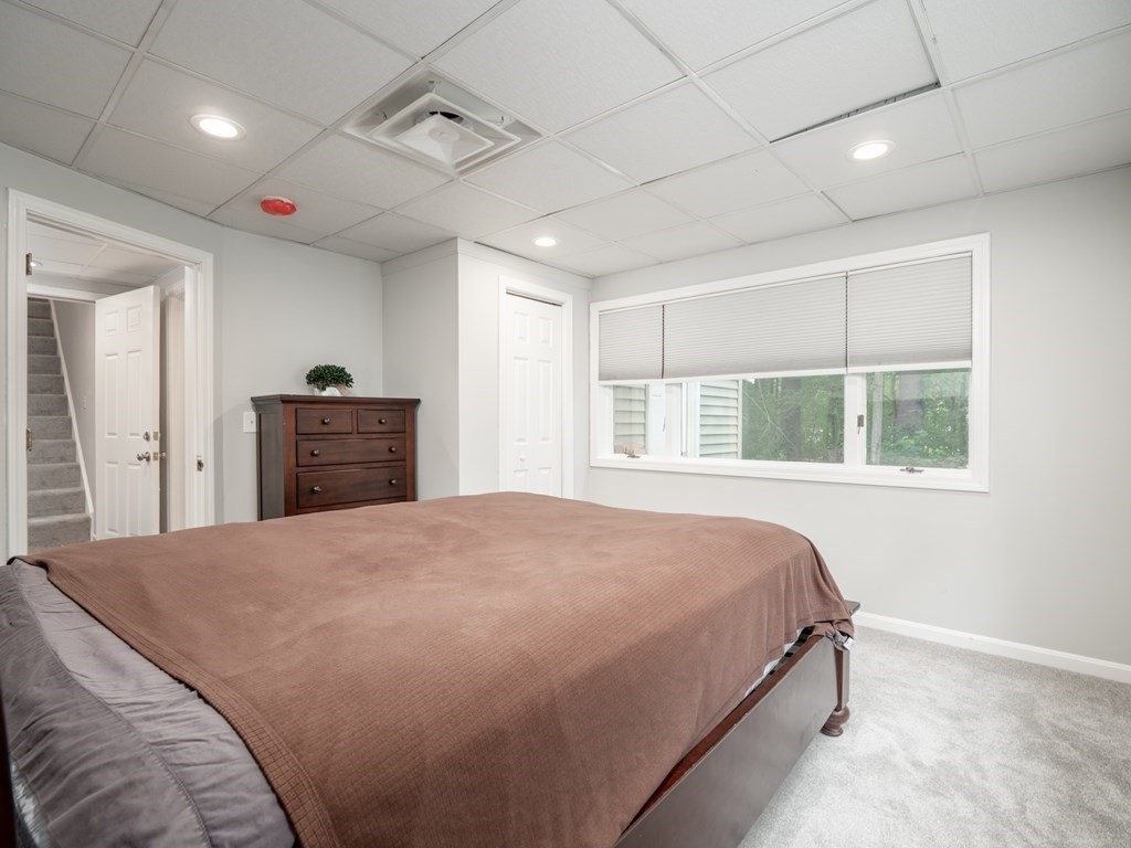 82 Rangeway Road Billerica, MA 01862 - Photo 18 of 40 a spacious bedroom with a large bed and a window