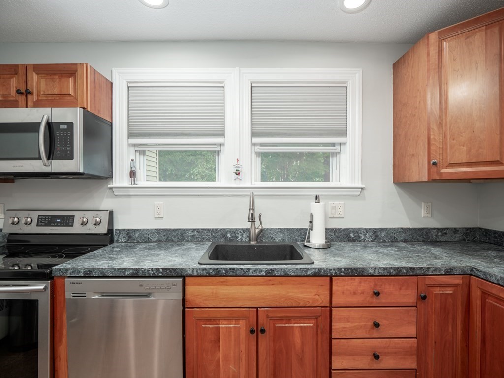 82 Rangeway Road Billerica, MA 01862 - Photo 26 of 40 a kitchen with stainless steel appliances granite countertop a sink and a granite counter tops