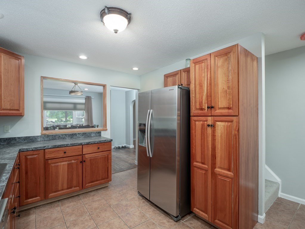 82 Rangeway Road Billerica, MA 01862 - Photo 28 of 40 a kitchen with stainless steel appliances granite countertop a refrigerator and a sink