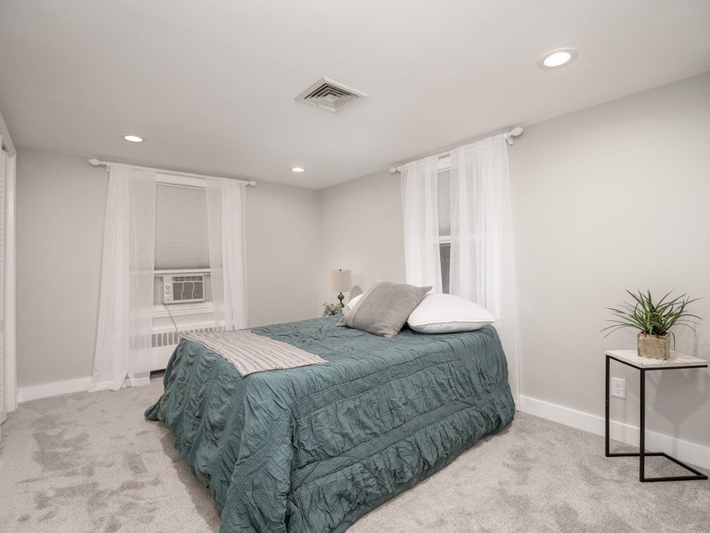 82 Rangeway Road Billerica, MA 01862 - Photo 5 of 40 a bedroom with a large bed and a potted plant