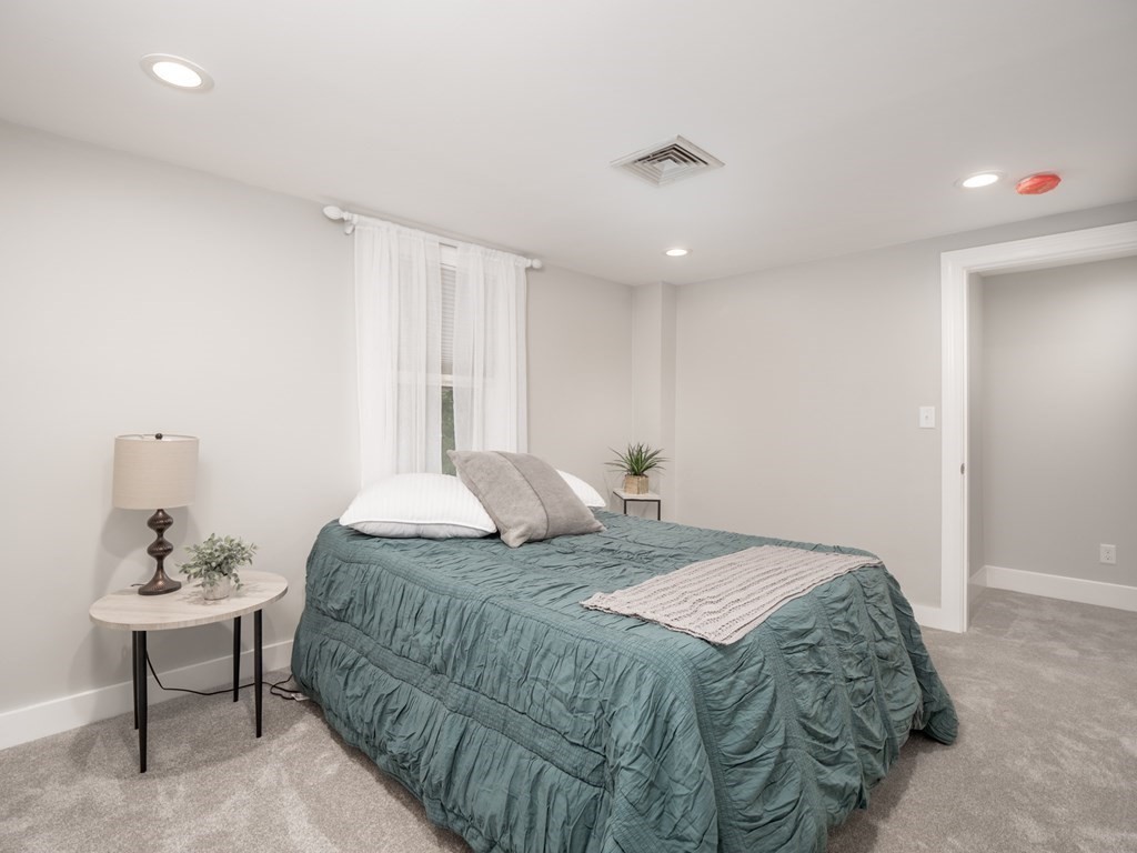 82 Rangeway Road Billerica, MA 01862 - Photo 6 of 40 a bedroom that has a bed and a table in it