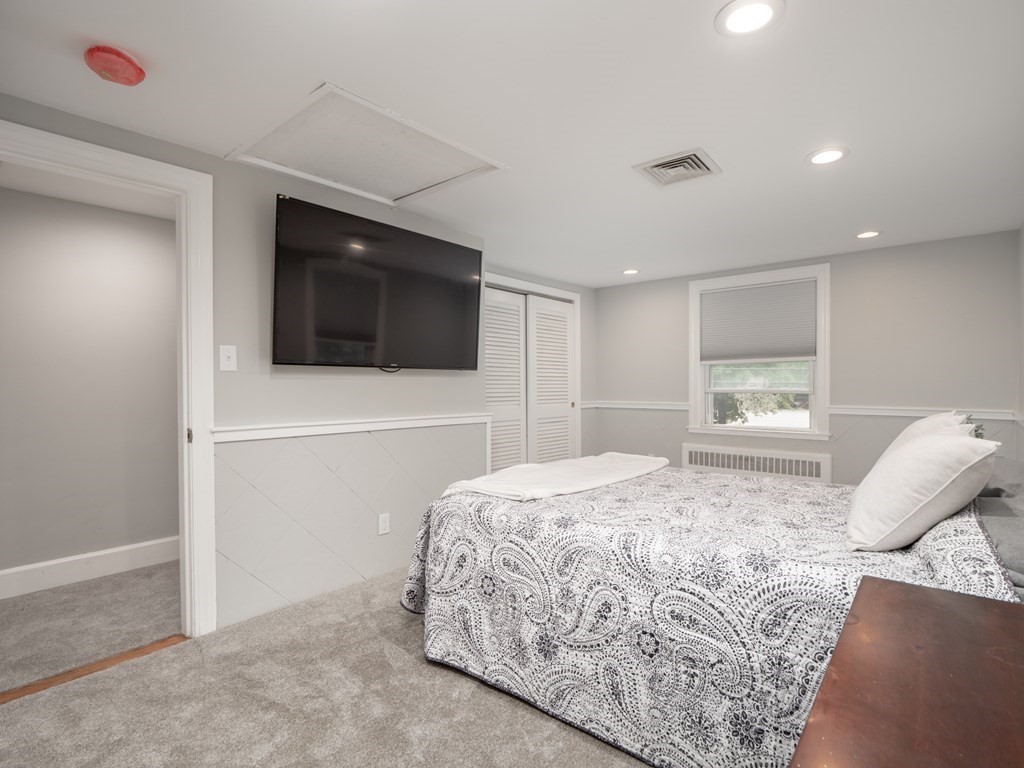 82 Rangeway Road Billerica, MA 01862 - Photo 10 of 40 a bedroom with a bed and a flat screen tv