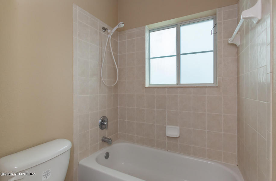 9745 Touchton Road, Unit 2028 Jacksonville, FL 32246 - Photo 7 of 20 a bath tub sitting next to a white toilet and a shower
