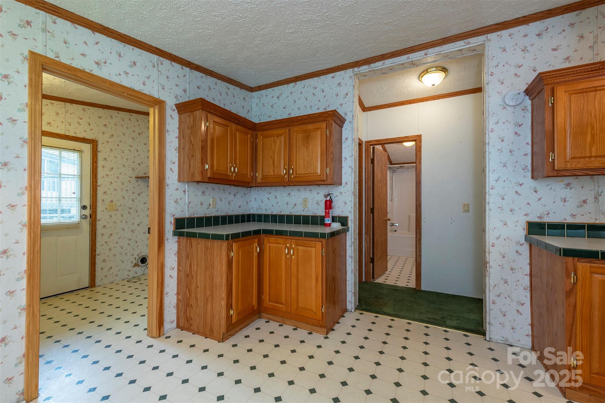 103 Sixth Street, Unit ~7&9 Black Mountain, NC 28711 - Photo 18 of 37 a hallway with granite countertop a refrigerator and a sink