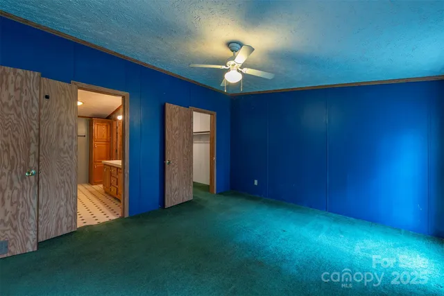 an empty room with windows and closet