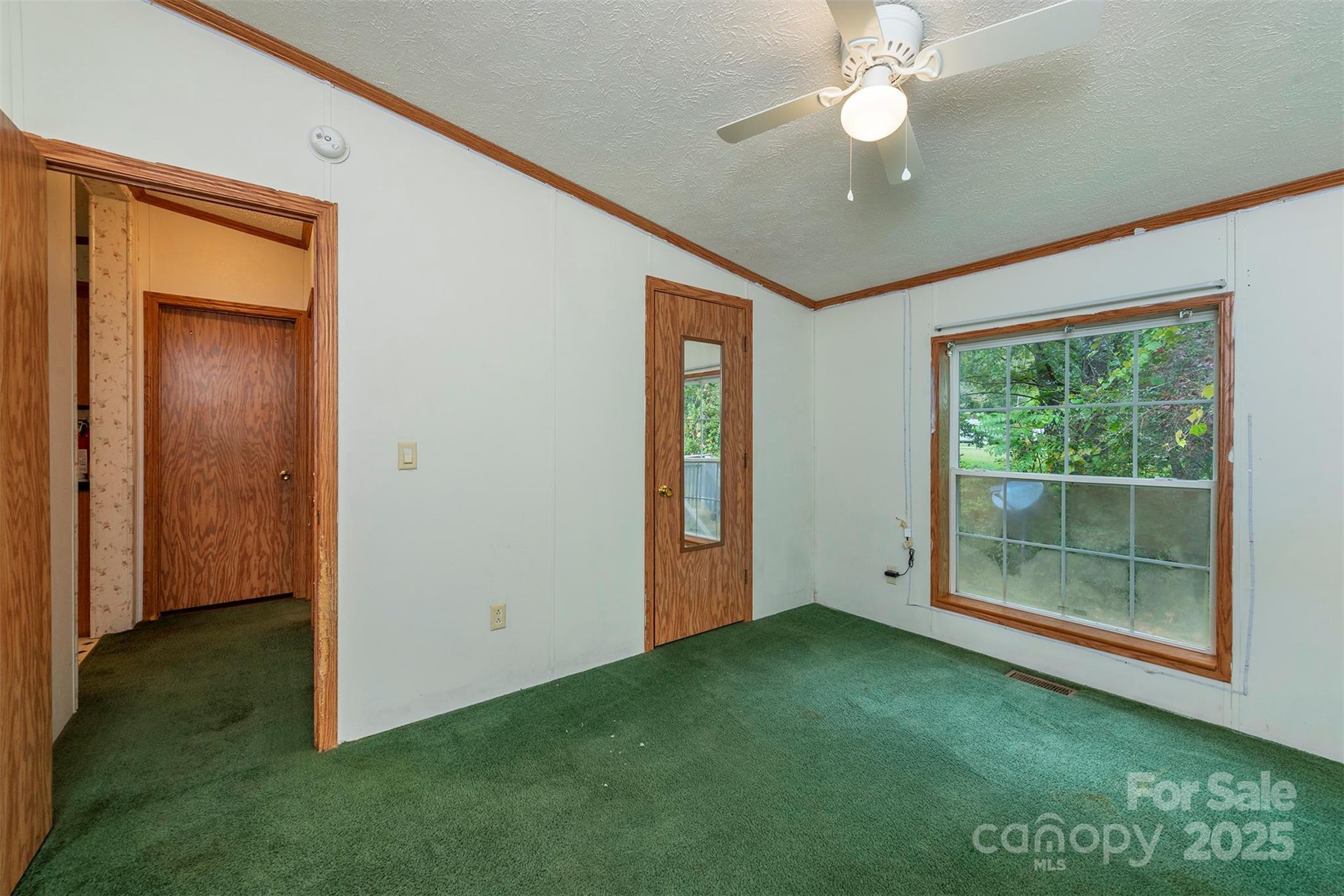 103 Sixth Street, Unit ~7&9 Black Mountain, NC 28711 - Photo 32 of 37 an empty room with fan and windows
