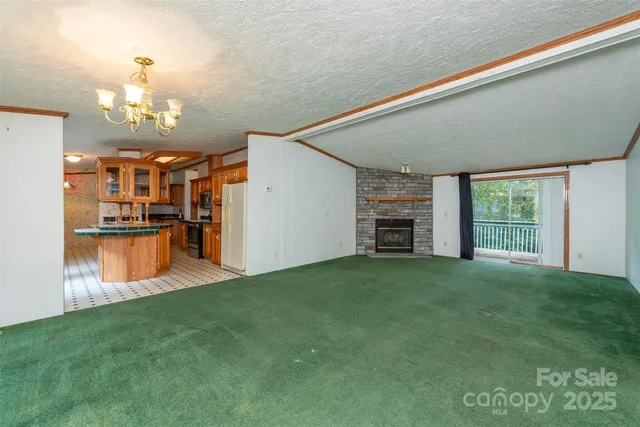 a view of a big room with windows and fire place