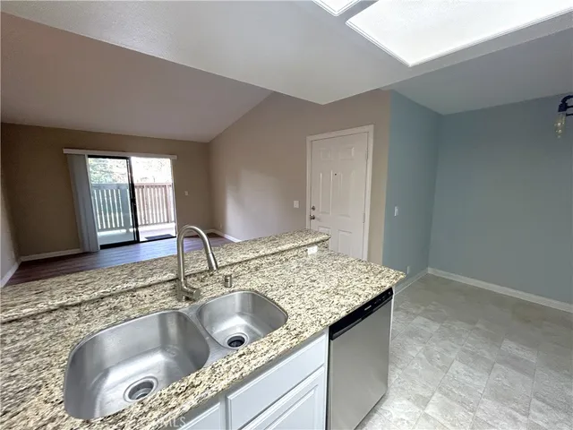 a bathroom with a granite countertop sink and mirror