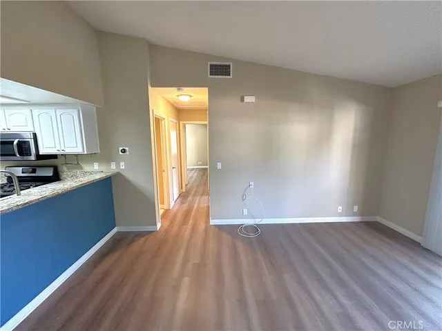 a view of kitchen with sink and wooden floor