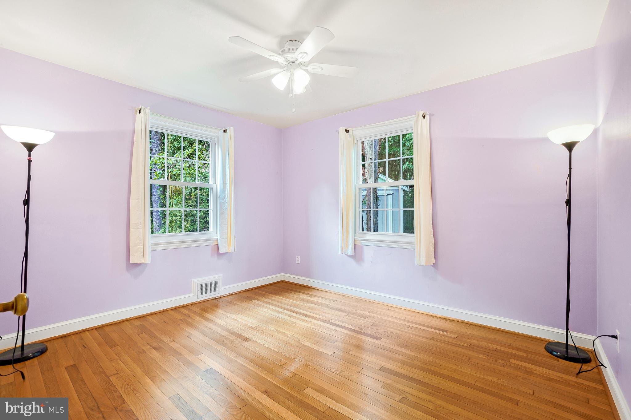 15400 Layhill Road Silver Spring, MD 20906 - Photo 24 of 45 main level bedroom with wood floors/ceiling fan
