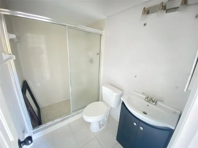 a bathroom with a glass shower door