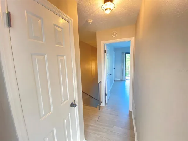 a view of a room with wooden floor and windows